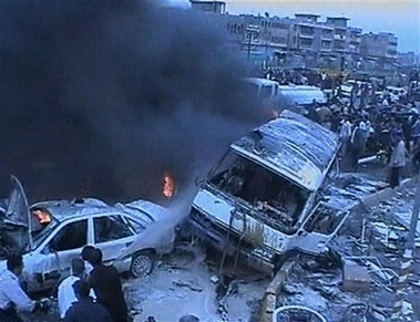 Smoke rises from damaged vehicles after a car bombing in the Sadr City area of Baghdad in this image taken from TV Thursday Nov. 23, 2006. In the deadliest attack on a sectarian enclave since the beginning of the Iraq war, suspected Sunni-Arab militants used five car bombs and two mortar rounds on the capital's Shiite Sadr City slum to kill at least 157 people and wound 257 on Thursday, police said. (AP