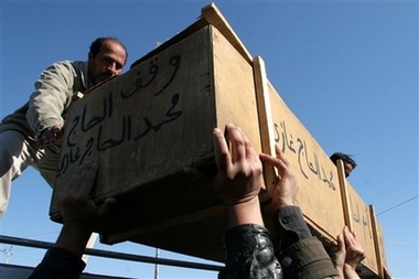 A coffin is delivered for funeral of a victim of the previous day's car bomb attack in Baghdad, in Shiite holy city of Najaf, Iraq, Sunday, Dec. 3, 3006. A triple car bombing struck a food market in a predominantly Shiite area in central Baghdad on Saturday, killing at least 51 people a day after a U.S.-Iraqi raid against Sunni insurgents in a nearby neighborhood. (AP 