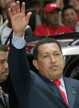 Venezuelan President Hugo Chavez greets his supporters upon his arrival to National Electoral Council to attend the ceremony wherehe is officially announced as the re-elected president in Caracas, Venezuela, Tuesday, Dec. 5, 2006.