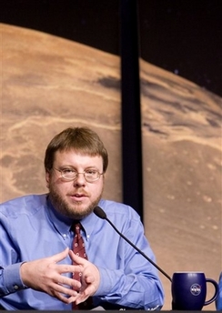Kenneth Edgett, a scientist at Malin Space Science Systems in San Diego, Calif., gestures during a news conference at NASA Headquarters in Washington, Wednesday, Dec. 6, 2006 to discuss the possibility that liquid water flowed on the surface of Mars as recently as several years ago, raising the possibility that the Red Planet could harbor an environment favorable to life. (AP 