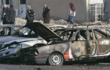 Burnt vehicles lie at the scene of a car bomb attack in a parking lot of Mahmoun University in Baghdad December 11, 2006. The attack killed one person and wounded four others, including two policemen. 