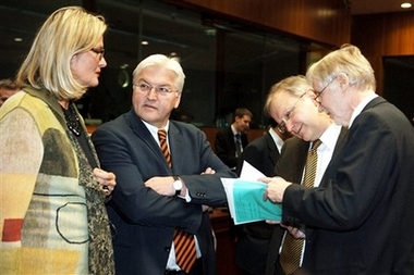 Germany's Foreign Minister Frank-Walter Steinmeier, 2nd left, talks with Austria's Foreign Minister Ursula Plassnik, left, while Filnland's Foreign Minister Erkki Tuomioja, right, shows documents to EU Commissioner for Enlargement Olli Rehn during a round table meeting of EU foreign ministers at the EU Council building in Brussels, Monday Dec. 11, 2006.