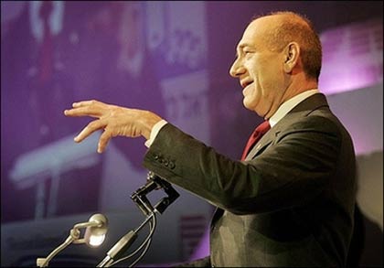 Israeli Prime Minister Ehud Olmert gestures as he speaks during a business conference in Tel Aviv. Olmert appeared to list his country for the first time among states which have the nuclear bomb, before his official spokesman issued a denial.(AFP