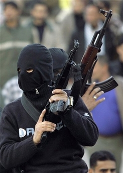 Palestinian gunmen from the Fatah Movement carry their weapons as they march in support of Palestinian President Mahmoud Abbas in the Jebaliya refugee camp, northern Gaza Strip, Sunday, Dec. 17, 2006. 