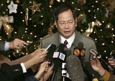 Chun Yung-woo, South Korea's chief negotiator for the six-party talks on North Korea's nuclear weapons programme, speaks to journalists in front of a Christmas tree at a hotel lobby in Beijing December 18, 2006. Five countries will stage a fresh push to persuade North Korea to forsake nuclear weapons in talks opening on Monday, with key negotiators wary over how Pyongyang will respond after staging its first atomic blast. [Reuters]