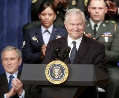 Secretary of Defense Robert Gates smiles moments before speaking after a swearing-in ceremony as President Bush claps, at the Pentagon, December 18, 2006.