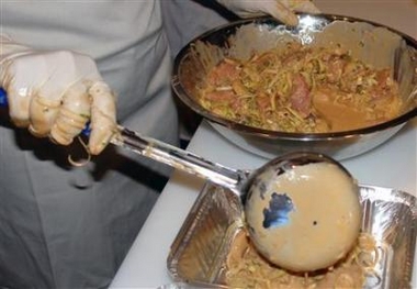 A meal is prepared in the kitchen of 'Dinners Made' in London in this undated handout photo released December 18, 2006.