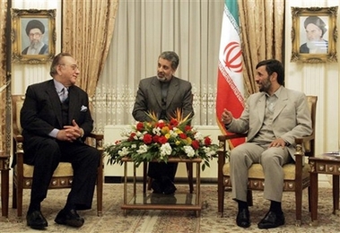 Iranian President Mahmoud Ahmadinejad, right, talks with the Pakistani Foreign Minister, Khursheed Kasuri, during their meeting in the city of Kermanshah 315 miles (525 kilometers) southwest of the capital Tehran, Iran, Wednesday, Dec. 20, 2006. Pictures of Iran's late revolutionary founder Ayatollah Khomeini, top right, and supreme leader Ayatollah Ali Khamenei, hang on the wall. (AP