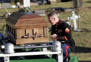 Marine Corporal Jesse Hassell next to the casket containing the remains of Marine Lance Corporal Brent E. Beeler following Beeler's funeral in Napoleon, Michigan, December 19, 2006. Beeler was killed in combat near Falluja. (Rebecca Cook/Reuters