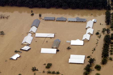 An aerial view shows schools building flooded in the district of Aceh Tamiang, Aceh province on December 24, 2006. Floods in Indonesia's Aceh and North Sumatra province have left at least 22 people dead and six missing, Health Ministry official said on Sunday. 