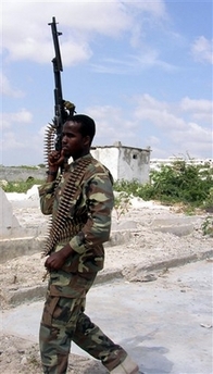 An Islamic Courts soldier patrols Mogadishu airport after the Ethiopian air force hit Mogadishu airport, Monday, Dec. 25, 2006.