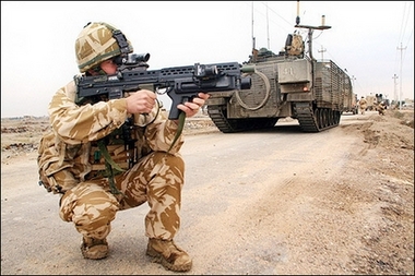 A British soldier takes a combat position during a patrol in the southern city of Basra. The violence in the war-torn capital Baghdad provided a grim backdrop to an unannounced visit by British Prime Minister Tony Blair, who flew in to offer support to his beleaguered Iraqi counterpart Nuri al-Maliki.(AFP
