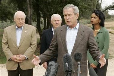 US President Bush speaks to reporters after a meeting with members of his National Security team about U.S. military involvement in Iraq, on the president's Central Texas ranch in Crawford, Texas, December 28, 2006. From L-R are: Vice President Cheney, Secretary of Defense Gates, Bush, and Secretary of State Rice. [Reuters] 