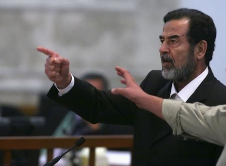 Former Iraqi President Saddam Hussein yells in court as he receives the verdict during his trial held under tight security in Baghdad's heavily fortified Green Zone November 5, 2006. 