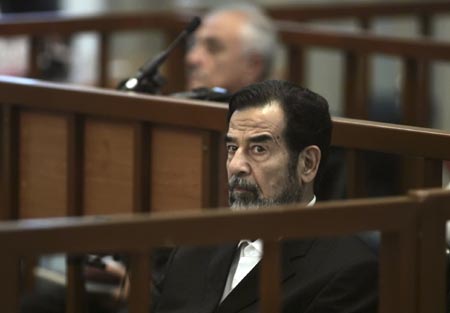 Former Iraqi President Saddam Hussein listens to prosecutors' statements during his trial in Baghdad's heavily fortified Green Zone October 30, 2006. 