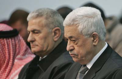 Palestinian President Mahmoud Abbas (R) attends Friday prayers at his headquarters in the West Bank city of Ramallah December 29, 2006. 
