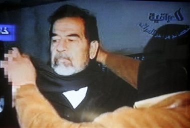 This video image released by Iraqi state television shows Saddam Hussein being led to the gallows by guards wearing ski masks moments before his execution Saturday Dec. 30. 2006. Clutching a Quran and refusing a hood, Saddam Hussein went to the gallows before sunrise Saturday, executed by vengeful countrymen after a quarter-century of remorseless brutality that killed countless thousands and led Iraq into disastrous wars against the United States and Iran. (AP 