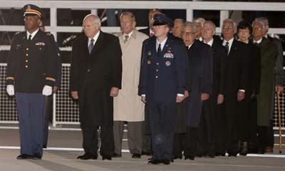 Honorary pallbearers including Vice President Dick Cheney (2nd L) watch the arrival of the casket of former U.S. President Gerald Ford at Andrews Air Force Base in Maryland December 30, 2006. From second left are Cheney, Ford's half brother Richard Ford, an unidentified military member, former Secretary of State Henry Kissinger, former National Security Adviser Brent Scowcroft, former Treasury Secretary Paul O'Neill, and former Housing and Urban Development Secretary Carla Hills.