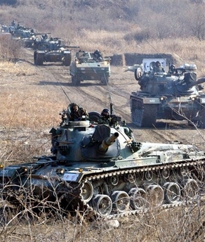 A tank unit of the Republic of Korea Army conduct the first drill of the new year to prepare for a possible North Korean surprise attack near the demilitarized zone between the two Koreas in Yeoncheon, north of Seoul, Thursday, Jan. 4, 2007. South Korea said Friday there are no particular signs that North Korea plans to conduct a second nuclear test, dismissing a media report on a possible nuclear test. (AP