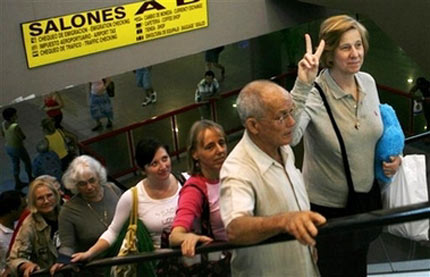 American activist Cindy Sheehan makes the victory signal as she walks up stairs along with, from right to left, Cuban Baptist minister Raul Suarez, Medea Benjamin, Tiffany Burns, Adele Welty and Ann Wright after they arrived at the Jose Marti airport in Havana, Saturday, Jan. 6, 2007. Cindy Sheehan, known as the 'peace mom', called for the closure of the U.S. military prison in Guantanamo, Cuba, several activists arrived to Cuba to draw attention to the nearly 400 terror suspects still held at the remote site. (AP Photo