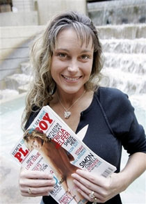 U.S. Air Force Staff Sgt. Michelle Manhart poses with the February issue of Playboy magazine in San Antonio, Thursday, Jan. 11, 2007. Manhart, who is featured in the February issue of Playboy magazine, has been relieved of her duties pending an investigation. (AP Photo/Eric Gay)