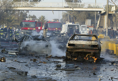 The wreckage of vehicles lies on a road after a car bomb attack near a university in Baghdad January 16, 2007. A car bomb near a university in eastern Baghdad killed 10 people and wounded 25 more on Tuesday, an Interior Ministry source said, adding that the toll may rise. 