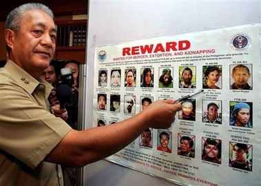 Philippine Marine Corps Commandant Maj. General Nelson Allaga points to the picture of Abu Sayyaf leader Abu Pula during a press conference Friday, Jan. 19, 2007 at the Philippine Navy headquarters in Manila. The military believed that the 9 militants killed yesterday during an encounter with the Marines in the island of Jolo in southern Philippines was under Radulan Sahiron and Abu Pula. The Philippine Marines are deploying fresh troops in the area to intensify a U.S.-backed operations against the al-Qaida linked Abu Sayyaf. (AP