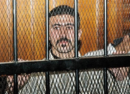 Egyptian mini-bus driver, Emad el-Kabir, 21, whom police sodomized, filmed his torture and transmitted it to the cell phones of the victim's friends in order to humiliate him, looks on behind the bars inside a courtroom on Tuesday, Jan. 9, 2007 in Cairo, where he was sentenced to three months in prison for `resisting authorities.' (AP Photo