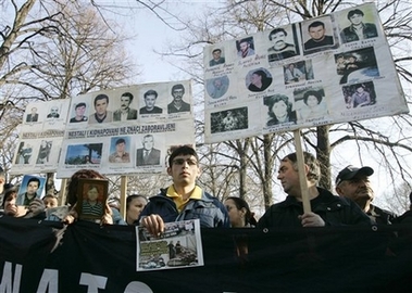 Kosovo Serbs hold pictures of relatives, who were missing or killed in Kosovo, during a protest in front of the Serbian presidency building, in Belgrade, Serbia, Friday, Feb. 2, 2007.