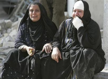 Women cry outside their home which was destroyed in a car bomb attack in Baghdad February 5, 2007.