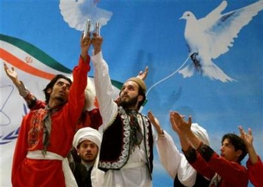 Iranian artists perform as they hold up samples of enriched uranium in Mashad, east of Tehran, April 11, 2006. Iran will seek to show a nation united behind its nuclear program on Sunday but pressure from the West and voices counselling caution at home have dampened prospects for a grand announcement about atomic progress. (Stringer/Reuters