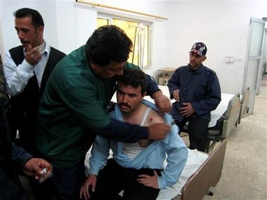 A policeman injured in car bombing receives treatment at a hospital in Kirkuk, Iraq, 290 kilometers (180 miles) north of Baghdad, Sunday, March 18, 2007. The man was injured when a road side bomb struck a police patrol 30 kilometers south of Kirkuk. Two policemen were killed and three were wounded in the attack. (AP 