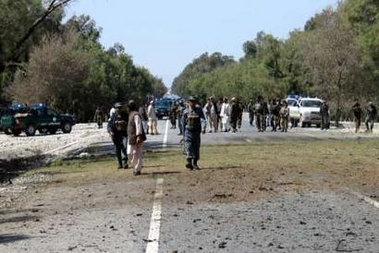 Afghan policemen inspect the site of a suicide bomb attack on a convoy of Western troops in the eastern province of Nangarhar March 23, 2007. 