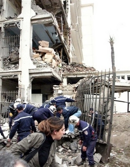 Rescuers and firemen search through rubble after a bomb exploded near the prime minister's office in Algiers, Wednesday, April 11, 2007.