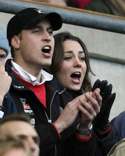 Prince William (L) and his girlfriend Kate Middleton react as England's Jason Robinson scores the first try during their Six Nations international rugby union match against Italy at Twickenham in London February 10, 2007.