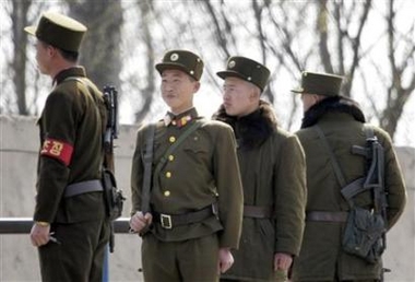 North Korean soldiers patrol the banks of the Yalu River near the North Korean town of Sinuiju opposite the Chinese border city of Dandong April 15, 2007.
