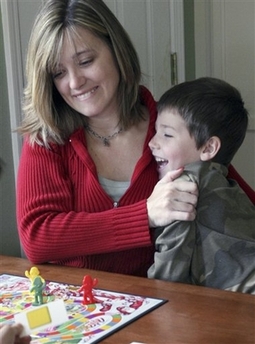 Kirsten Whipple enjoys a board game with her son Chase, 8, at their home in Northbrook, Ill., on Sunday, April 15, 2007.