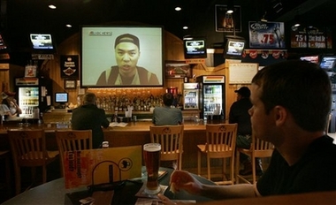 Customers watch a video of Cho Seung-Hui on the NBC Nightly News as they dine in a local restaurant Blacksburg, Va. on Wednesday, April 18, 2007.