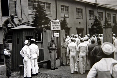 In this undated image released by the Yokosuka City Council in Japan, U.S. sailors gather in front of a Yasu-ura House 'comfort station' in Yokosuka, south of Tokyo. Japan's practice of enslaving women to provide sex for its troops in World War II has a little-known sequel: After its surrender - with tacit approval from the U.S. occupation authorities - Japan set up a similar 'comfort women' system for American GIs. (AP 