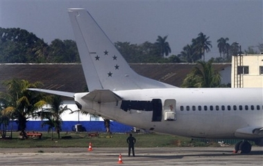 An airplane, that three men apparently tried to hijack early Wednesday, sits at an hangar at the airport in Havana, Thursday, May 3, 2007. According to an official statement released by authorities, at least two men, that abandoned their military post last week, tried to hijack the plane to fly to the United States, killing a military officer during their attempt. According to the statement the two men were later captured by authorities.