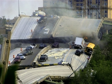 Vehicles are scattered along the broken remains of the Interstate 35W bridge, which stretches between Minneapolis and St. Paul, after it collapsed into the Mississippi River during evening rush hour Wednesday, Aug. 1, 2007, sending vehicles, tons of concrete and twisted metal crashing into the water. (AP