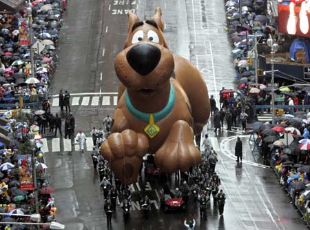 Macy's balloons fly through rain, wind