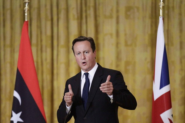 Cameron, in Tripoli, says UK will help hunt Gadhafi