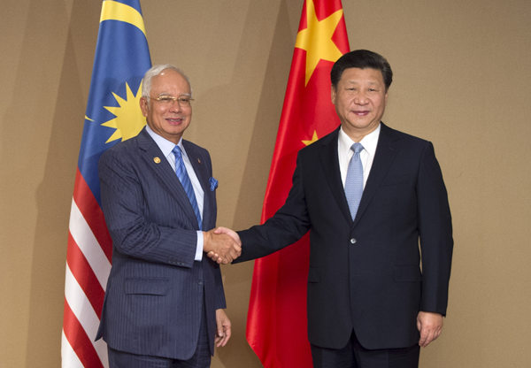 Xi pledges 'priority' to ties with Malaysia in China's neighborhood diplomacy