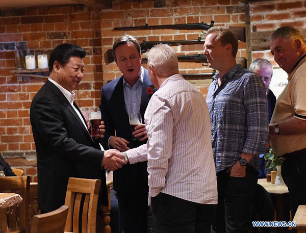 British PM Cameron treats President Xi to beer, fish and chips in English pub