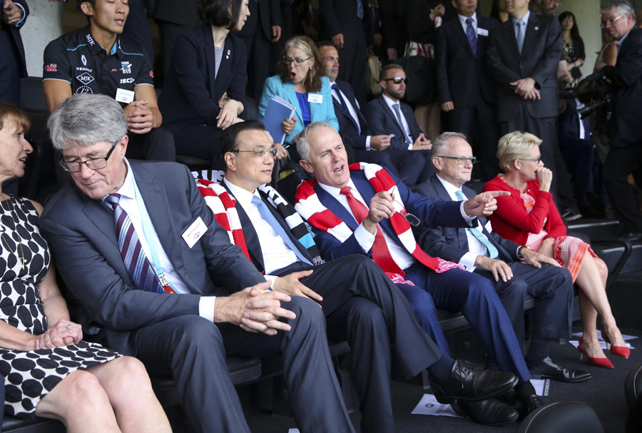 Premier Li and Australia's Turnbull watch football game