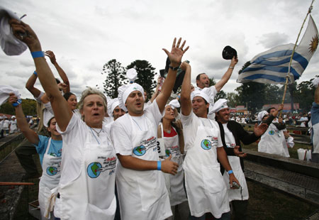Uruguayans celebrate after successfully being entered into the Guinness World Records for 'Biggest barbeque in the World', in Montevideo, April 13, 2008. In the attempt to get the Guinness World Record, 1,252 people grilled 12,000 kilograms of beef on a single grill totalling 1,500 metres in length. [Agencies]