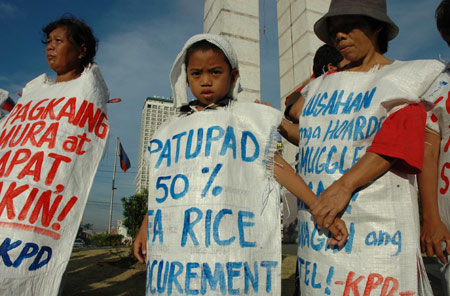 Filipinos wearing rice sacks protest on a street in Manila, the Philippines, April 16, 2008. The protestors are calling for stronger measures from the National Food Authority to increase the proportion of home-produced rice in its food reserve while punishing the regraters. The Philippines, one of the world's major consumers and importers of rice, is caught in the middle of a worsening global rice supply shortage.