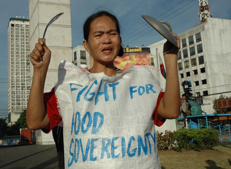 A woman wears a rice sack during a protest on a street in Manila, the Philippines, April 16, 2008. The protestors are calling for stronger measures from the National Food Authority to increase the proportion of home-produced rice in its food reserve while punishing the regraters. The Philippines, one of the world's major consumers and importers of rice, is caught in the middle of a worsening global rice supply shortage. 