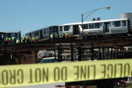 Rescue workers arrive at the scene where a four-car train derailed in Chicago's South Side, US, May 28, 2008. Twenty-four people were reported injured. 
